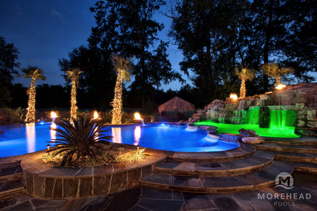 Luxury pool at night with blue and green lights