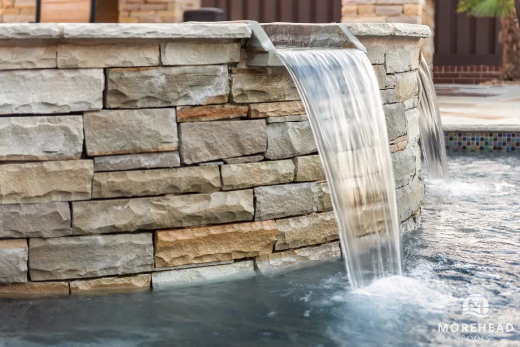close up of a water feature in stone pool | Morehead Pools